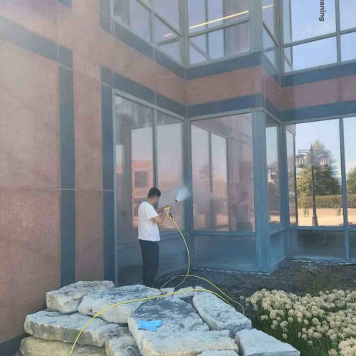 a professional cleaning windows of a building in Bartlett, Illinois